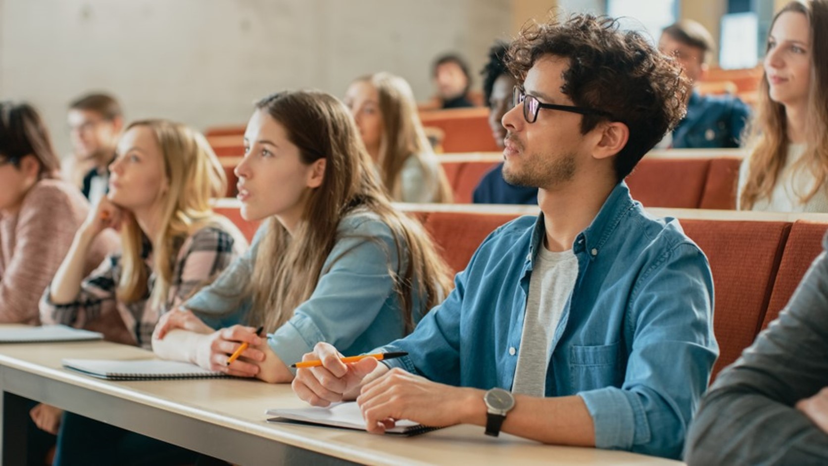 Attentive students in college lecture room