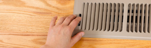 Person adjusting the heating vent