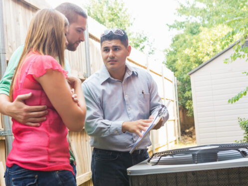 HVAC technician explaining to homeowners